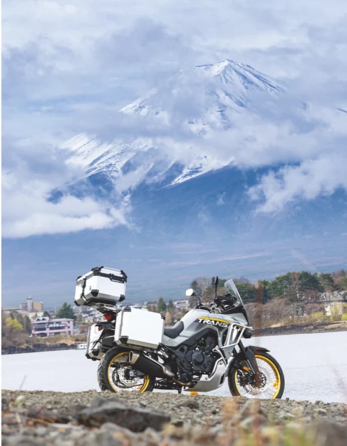 COOCASE aluminium top and side cases on an adventure motorcycle by a lake